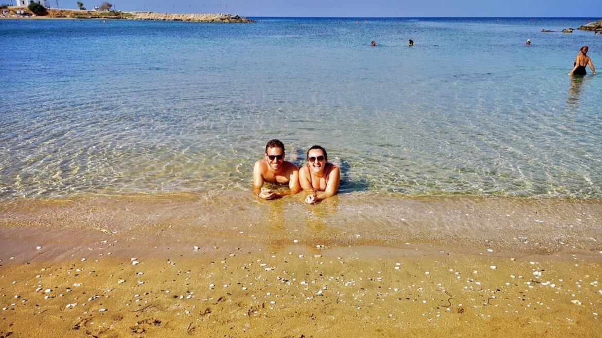 two people lying on the beach in the sea in Cyprus