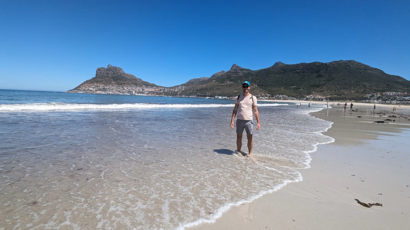 Aaron with his feet in the sea at Hout Bay Cape Town South Africa