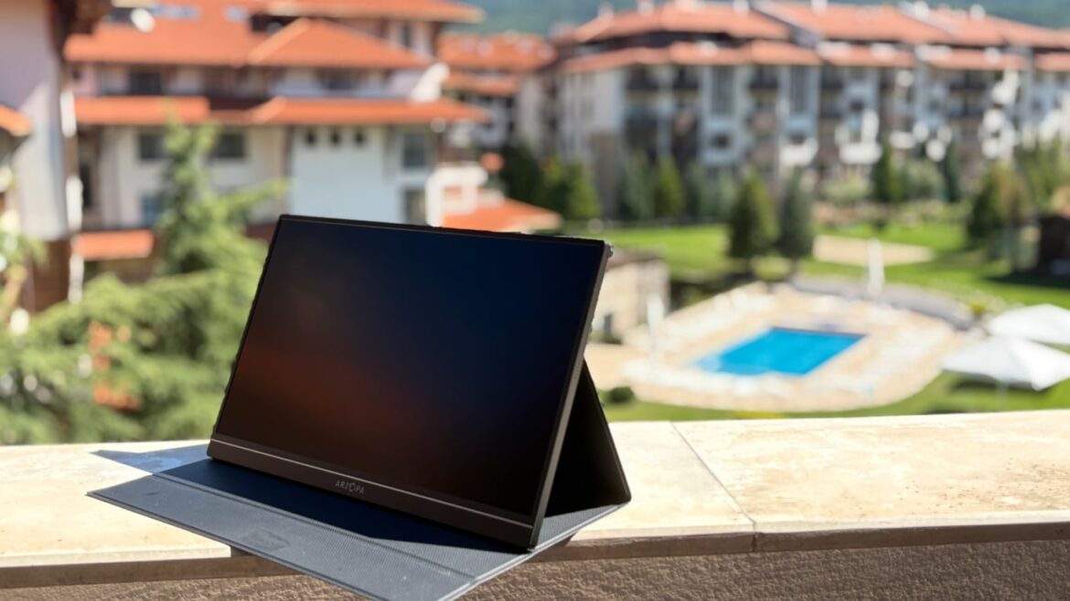 Remote work setup in Bansko Bulgaria Additional screen on foldable stand with pool and mountains in background